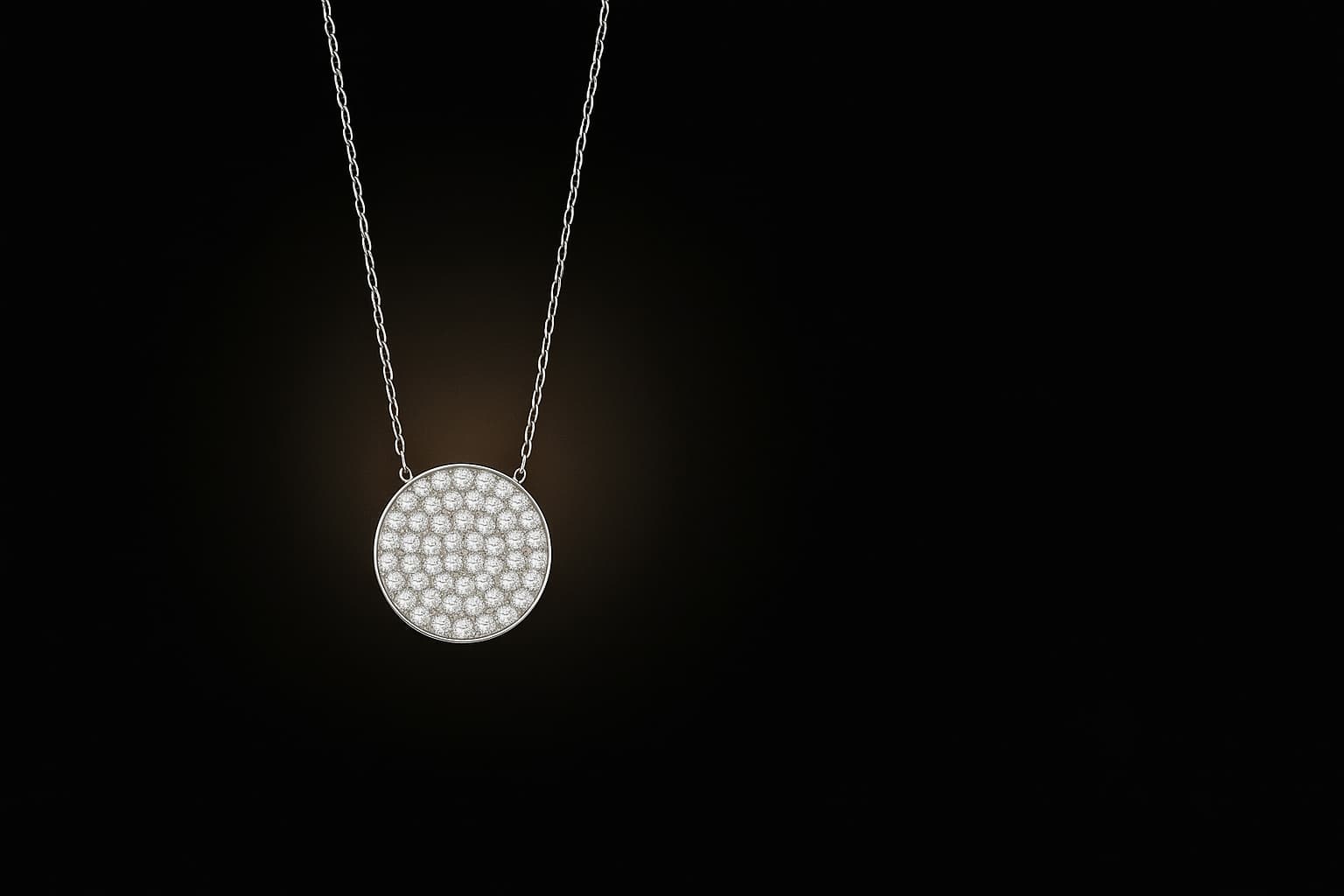 Silver necklace with a round pendant on a black background
